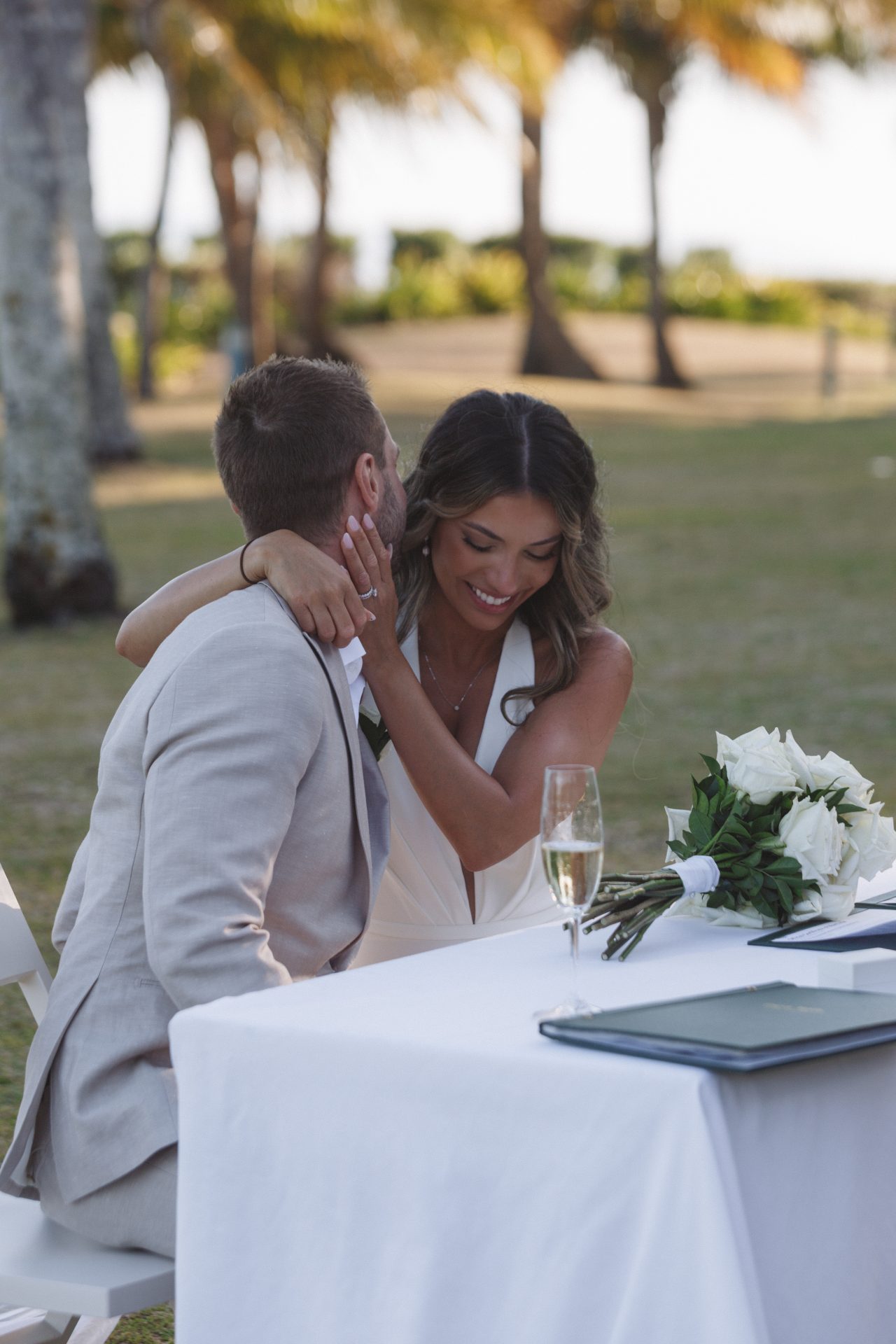 Wedding ceremony setup on Hayman Island beach with tropical flowers and ocean views